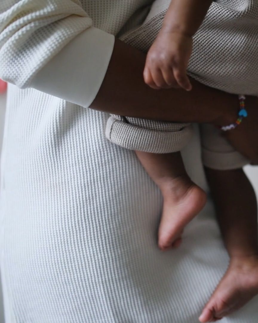 A parent holding their baby close